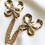 Thumbnail: Yves Saint Laurent vergulde dubbele strikjes broche