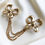 Thumbnail: Yves Saint Laurent vergulde dubbele strikjes broche