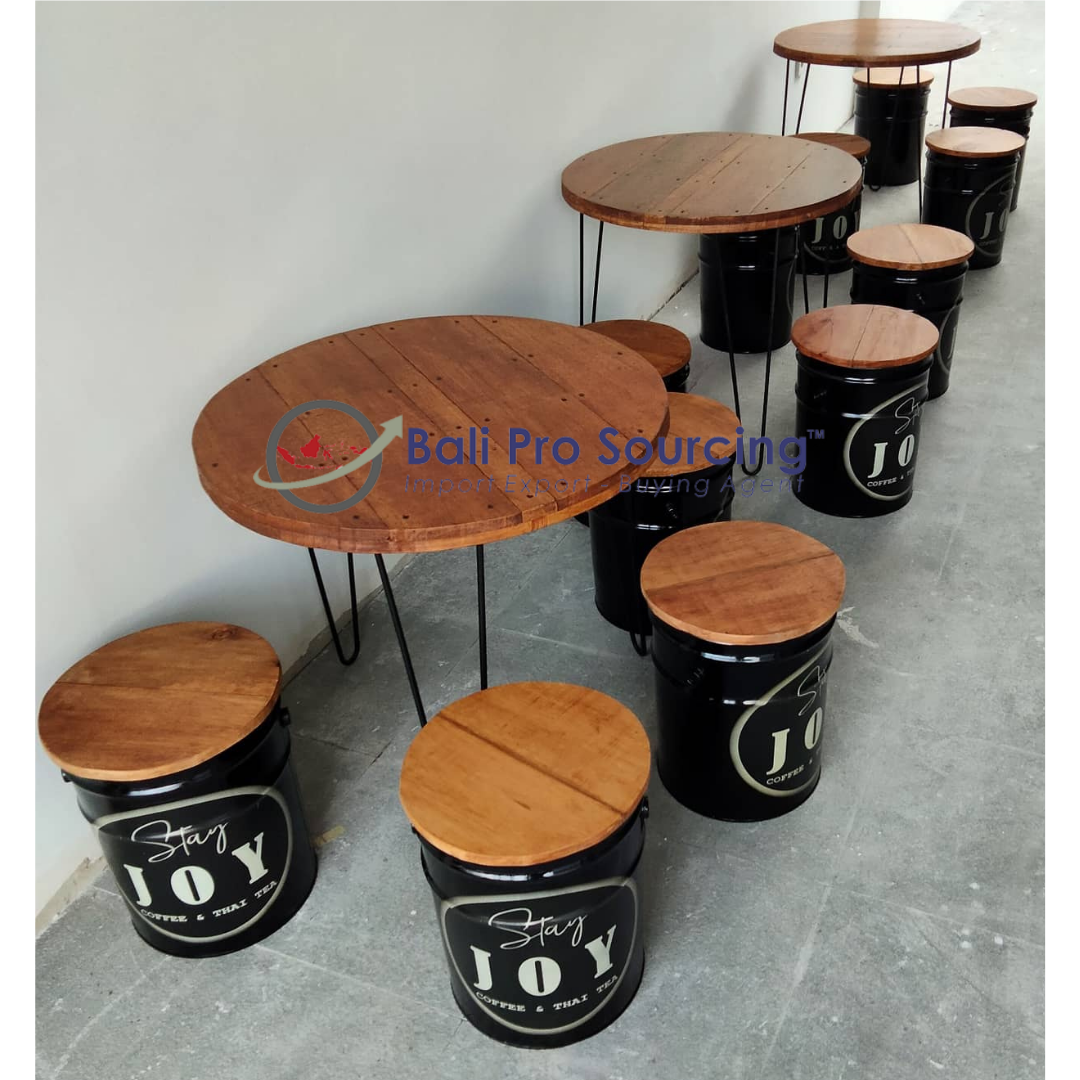 A Set Of Table And Recycled Drum Chairs