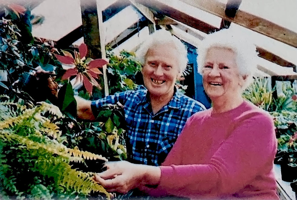 Leslie and Mabel, my grandparents, where they often were ... amongst the plants.