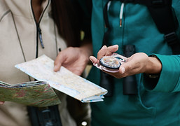 Team with a guide and a compass in hand