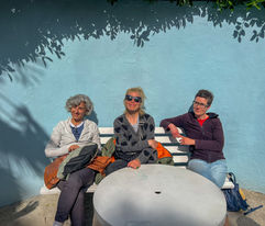 A group of Skool students sitting in the sunshine 