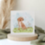 Card featuring a cute spaniel puppy in a field with flowers