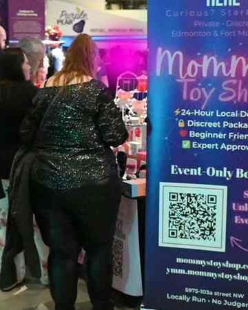 Evening crowd engaging with local Edmonton adult store booth at Dark Matters