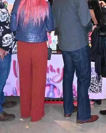 Attendees browsing adult wellness products at Mommys Toy Shop booth in Edmonton