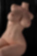 Premium silicone sex doll torso posed against black panel backdrop, showcasing realistic curves, soft skin texture, and sculp