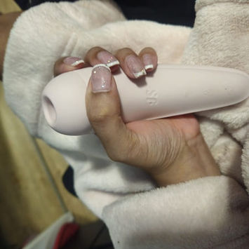 Casual handheld photo of a Satisfyer Curvy 2+ toy submitted as part of a customer review