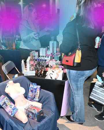 Attendees browsing adult wellness products at Mommys Toy Shop booth in Edmonton