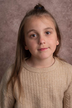 young girl headshots on brown textured background