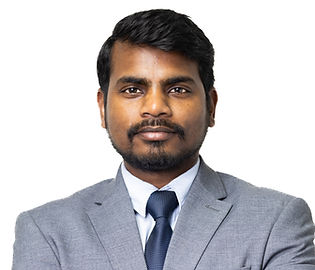 Man in gray suit with folded arms, looking at the camera.