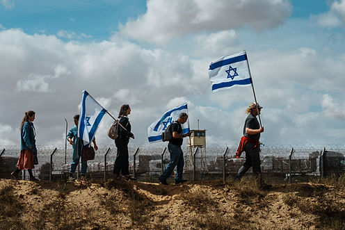 Far-right Israeli protesters march toward a border crossing with the goal of blocking aid shipments from getting into Gaza on March 7, 2024.