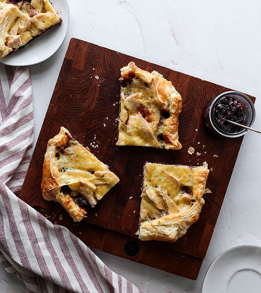 puff pastry tart filled with cherry sauce, turkey and melted cheese.