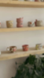 hand made cute ceramic cups on shelf