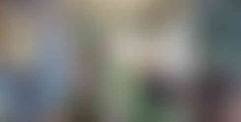 A vibrant pop art-style mural featuring a colorful, distorted rendition of the Mona Lisa, blending bold graffiti elements with modern street art aesthetics.