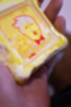 A yellow-bordered Trump caricature magnet next to a classic American Beauty illustration