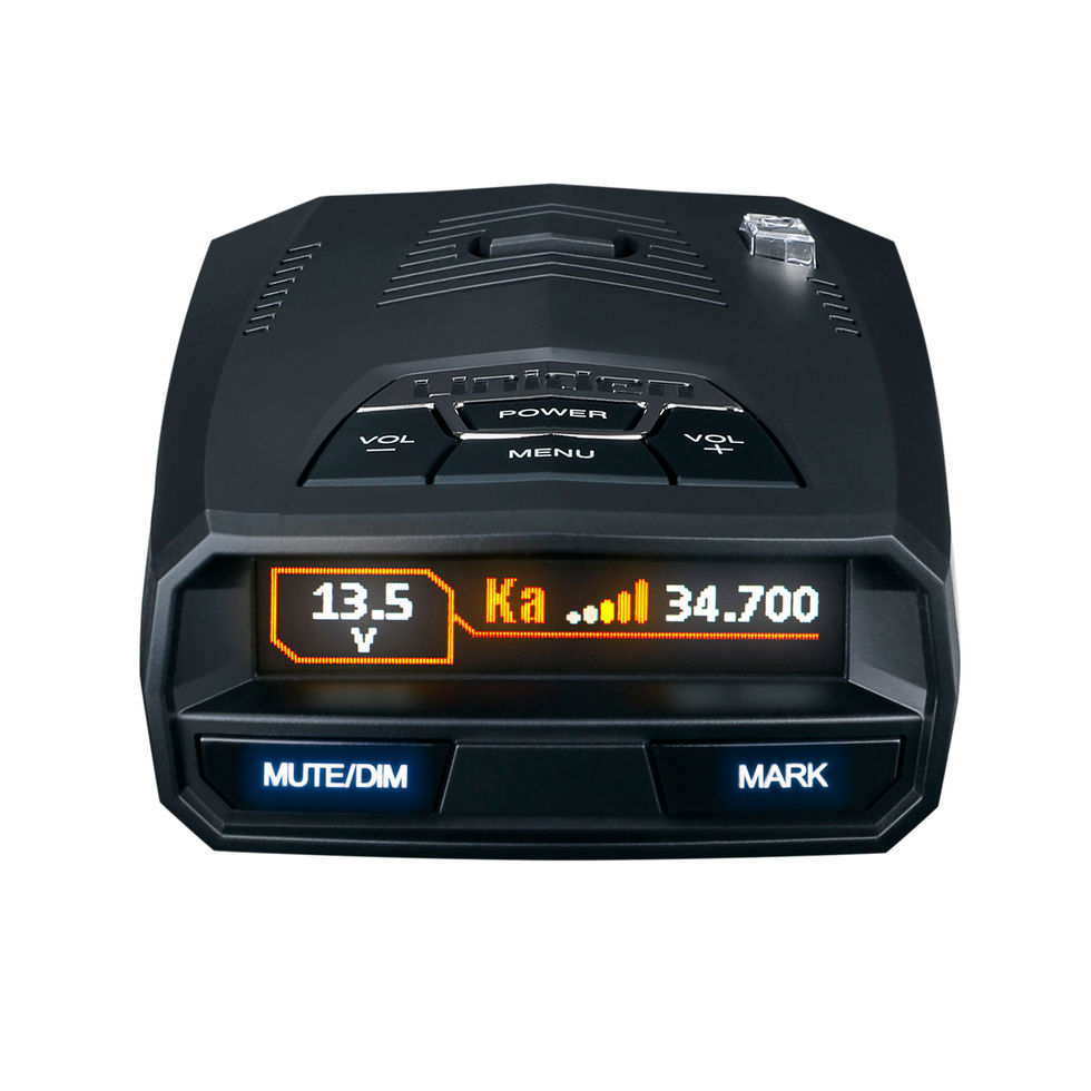 Product photo of radar detector with illuminated LED display and buttons, captured from a high front view to emphasize user interface.