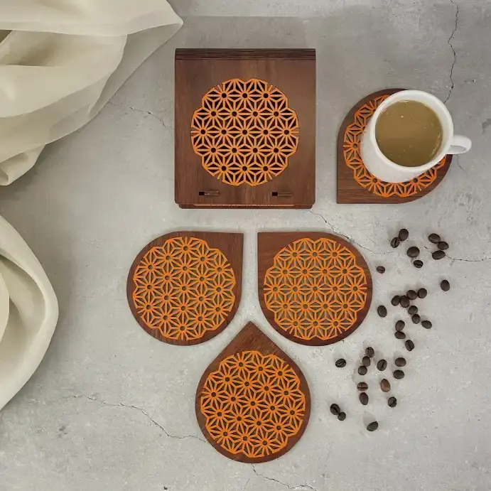 Asanoha laser cut coaster set with designer box in walnut and orange with coffee beans, flat lay lifestyle image