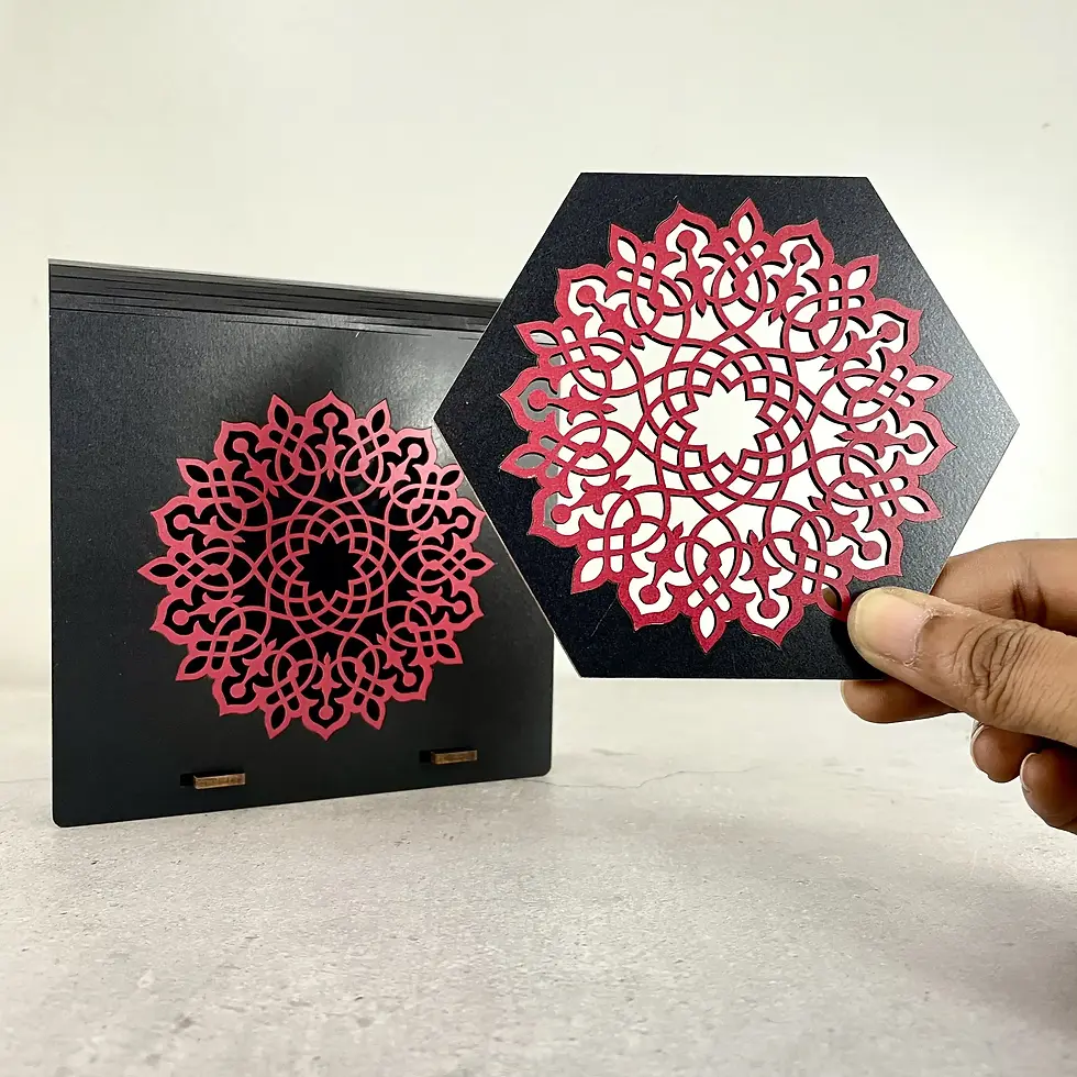 Thumbnail: Aurelia laser cut coaster with designer box in black and red, coaster held in hand