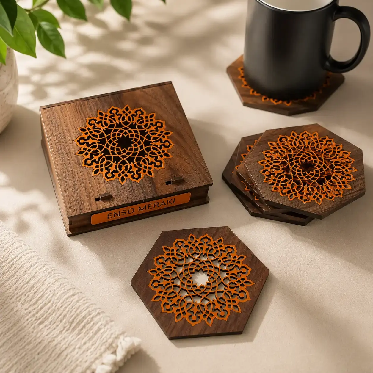 Aurelia lasercut coaster set in walnut & orange with designer box with mug on a table lifestyle shot