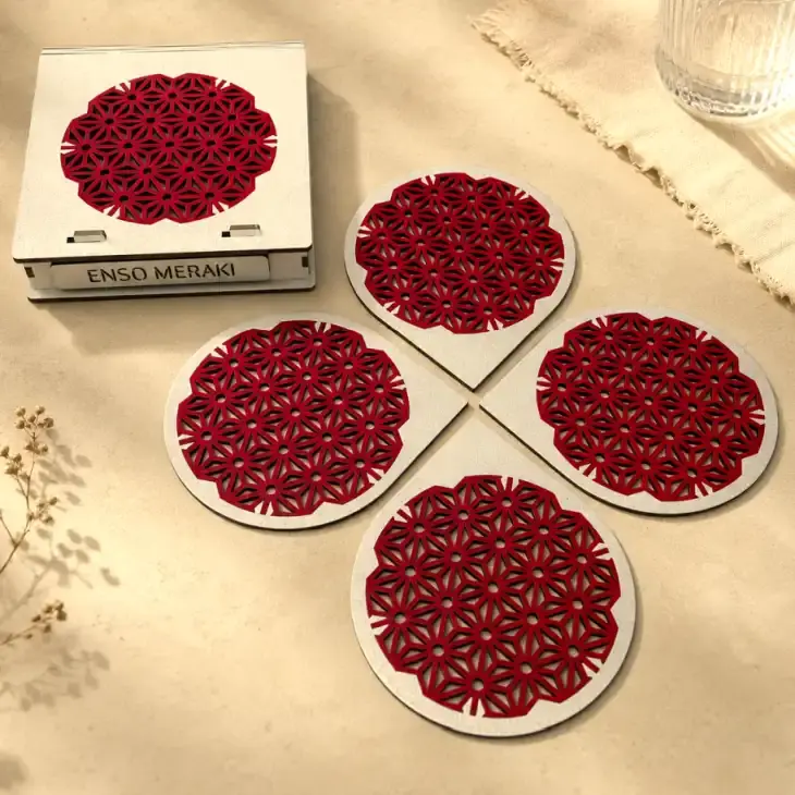 Thumbnail: Asanoha laser cut coaster set in silver & red on beige background, angled lifestyle image