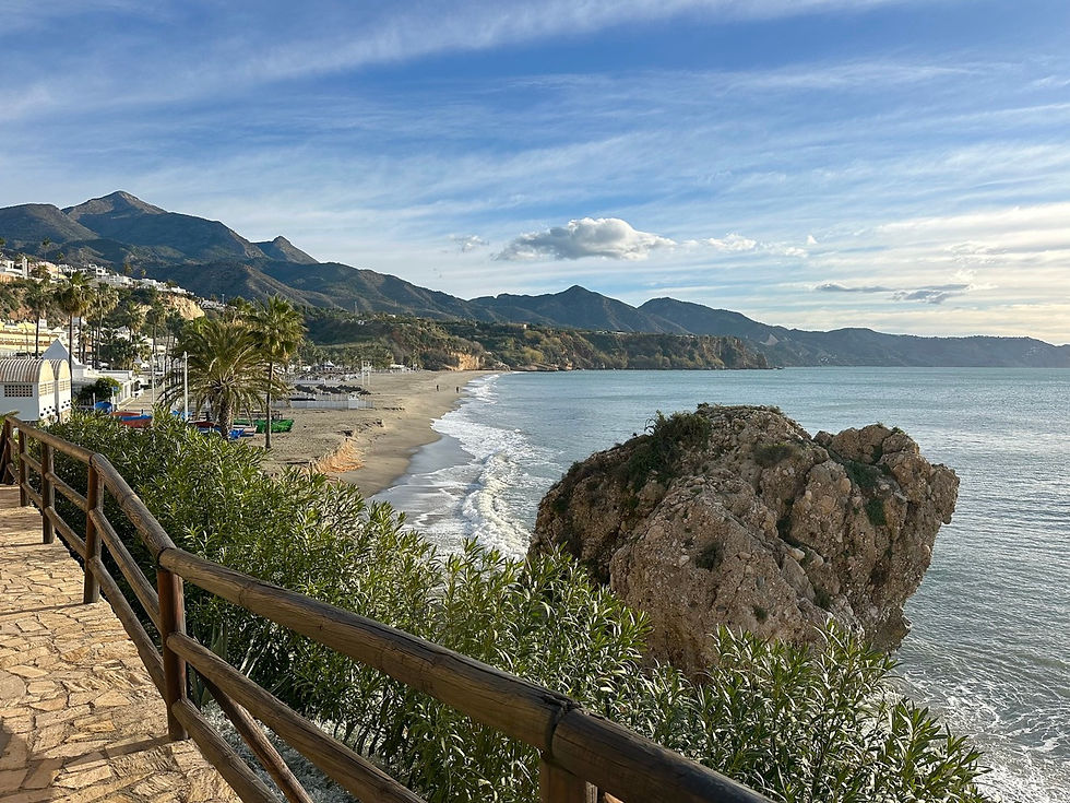 Sunny conditions at Playa Burriana in Nerja after stormy weather, bright light, calm sea and wide sandy beach