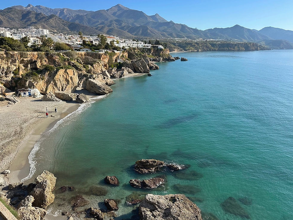 View from Balcón de Europa in Nerja towards Playa Calahonda with white houses and mountains in the background