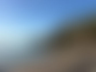 Sunny winter day at Playa Carabeillo in Nerja, clear sky, calm sea and golden sand