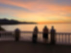 Warm golden sea-sunrise seen from Mirador del Bendito in Nerja, two elderly men enjoying the view
