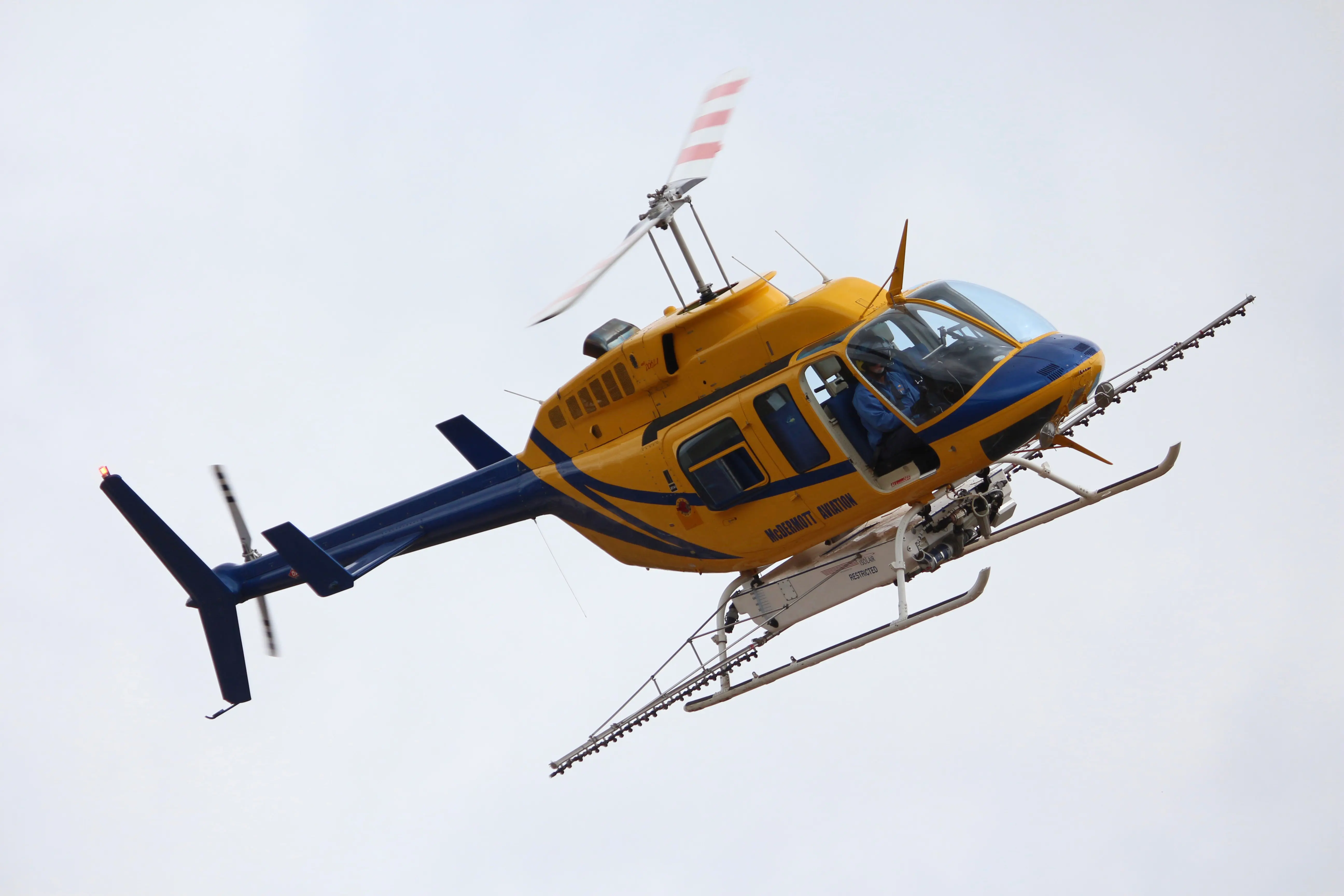 Yellow Helicopter spraying fertilizer