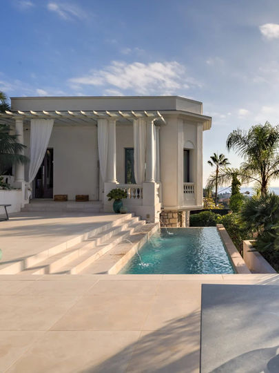 White villa with pool and palm trees on the French Riviera