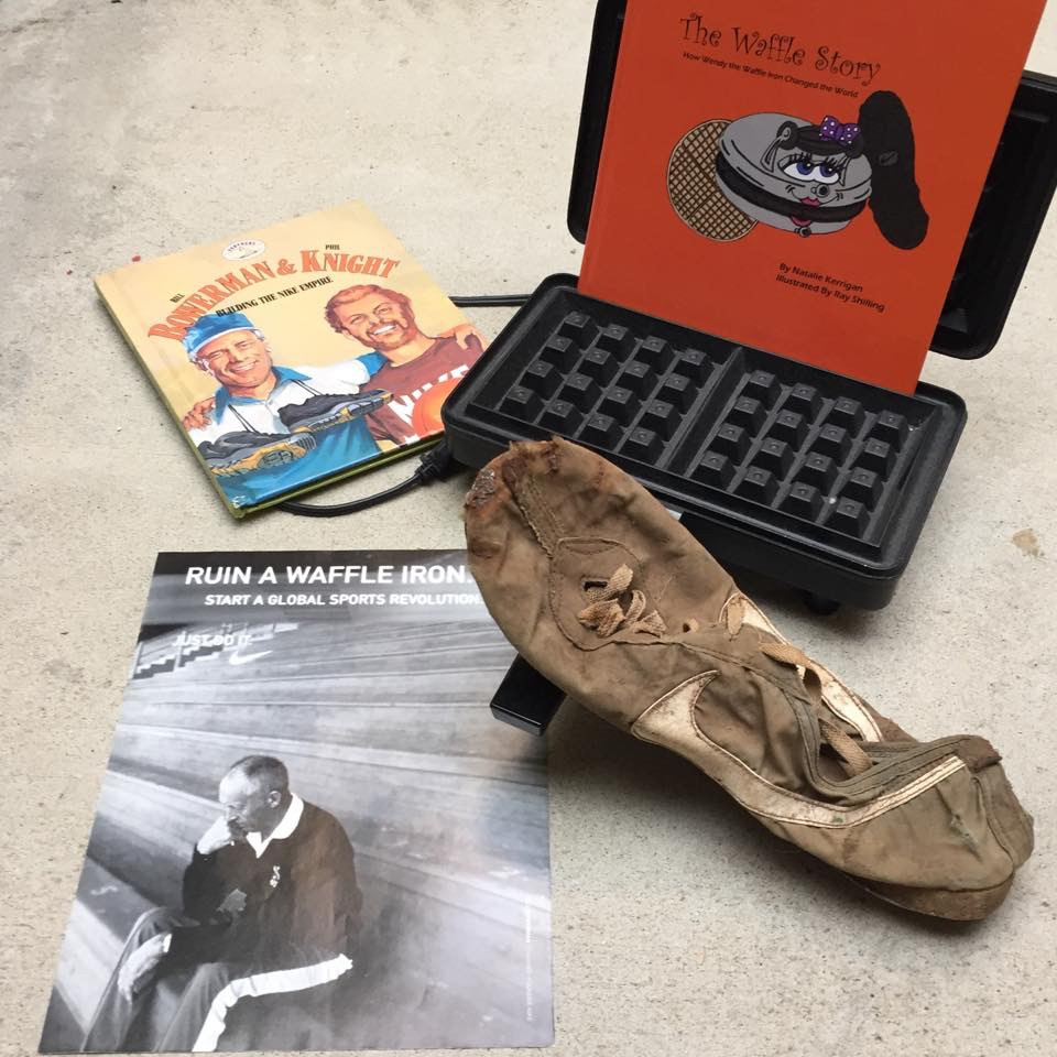 Bill Bowerman's first waffle running shoe and a replica of the waffle iron he destroyed at home making the product.