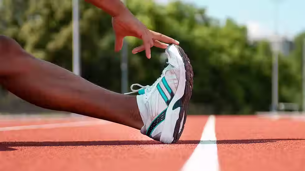 athlete-stretching-on-track-1296x728-header.avif