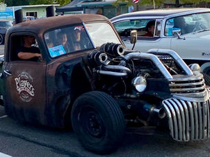 Two  cars coasting in car show event: Kool April Night Cruise Night