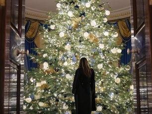 Melania Trump next to Christmas tree
