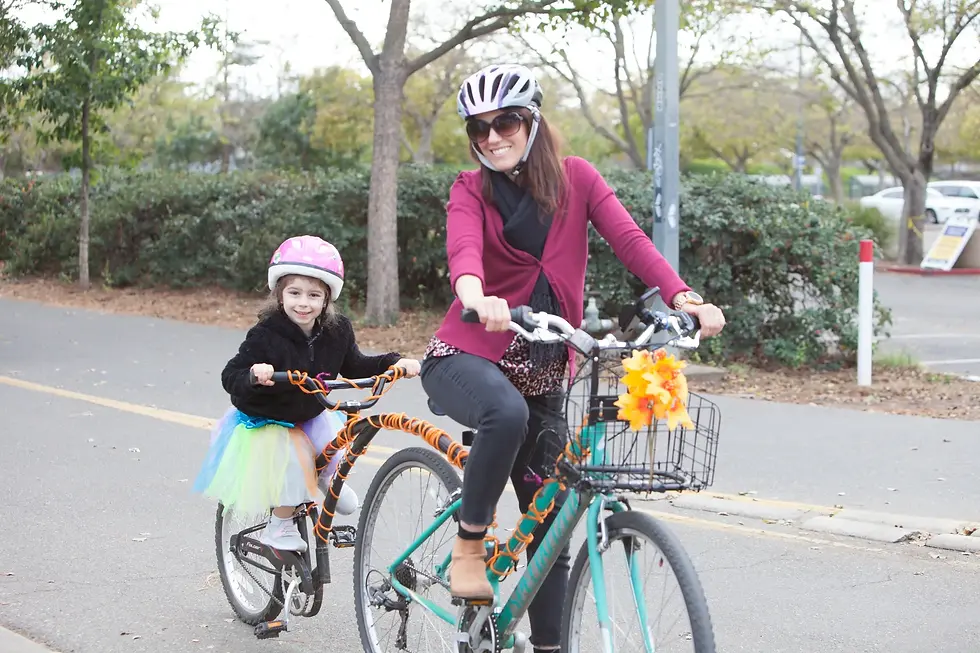 A mother and daughter ride the zombie bike parade together on a tandem. Photo: Timothy Wilkinson Photography