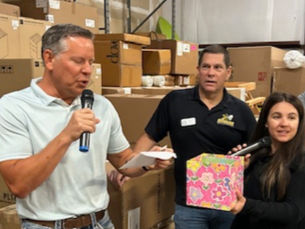 Caliber Office Furniture owner, Chris Cable, awards raffle prizes with Dave Silva and Debe Hopkins