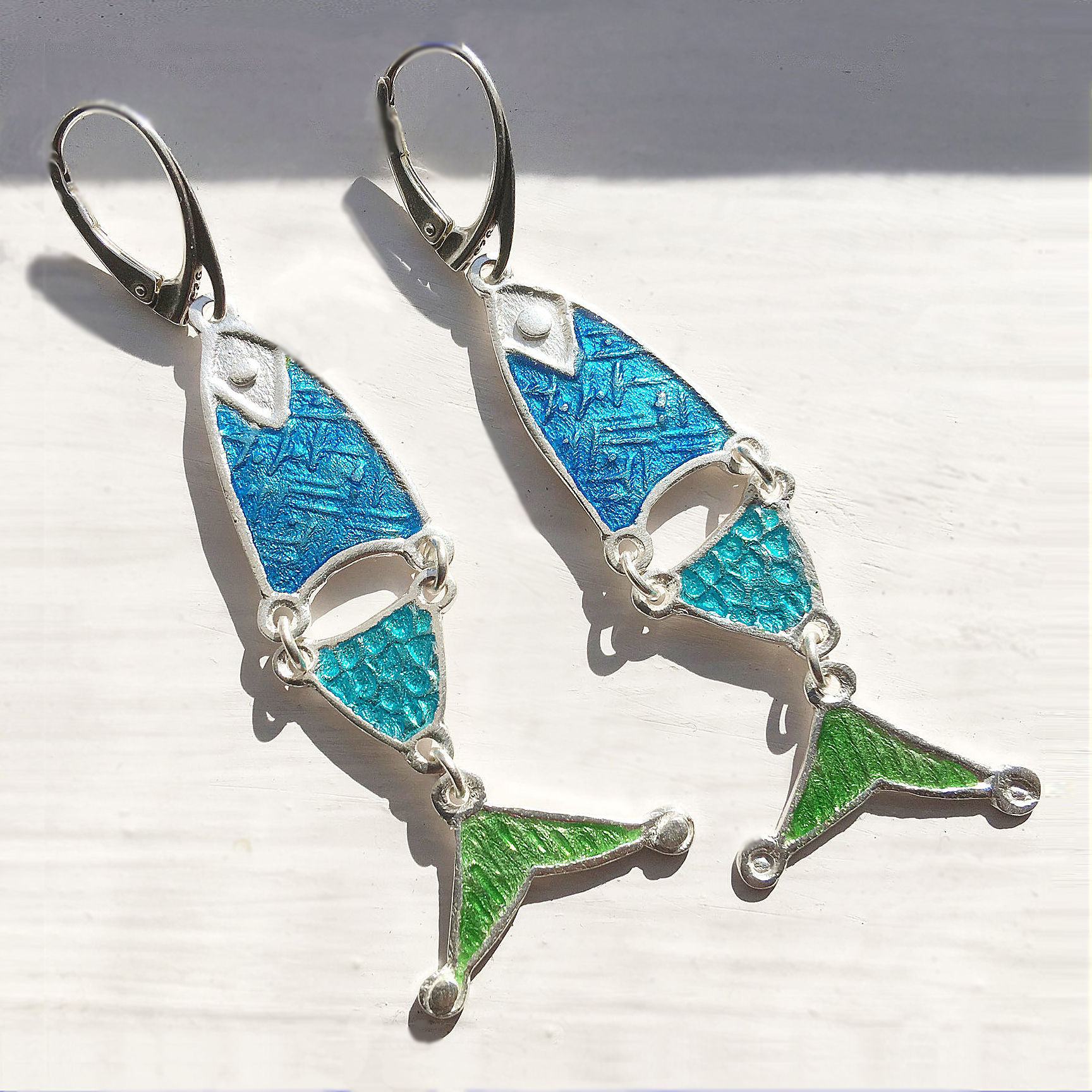 Silver earrings in the shape of a fish, with three colors of vitreous enamel