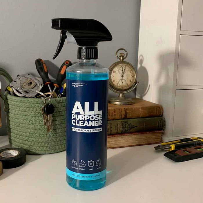All Purpose Cleaner bottle on desk with vintage clock and books — versatile cleaner for hard surfaces