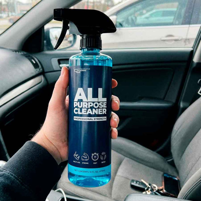 All Purpose Cleaner spray bottle in car interior — cleans seats dashboard and plastic trim surfaces
