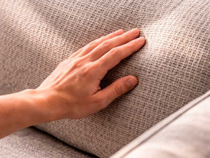 Close-up of light gray woven sofa upholstery texture, used for couch and upholstery cleaning guidance in NYC.