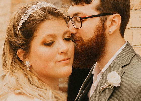 groom kissing brides cheek on wedding day