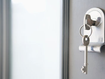 Physical keys hang on a door, key to success