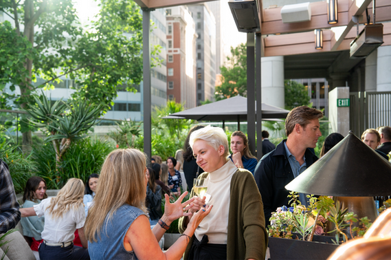Guests mingling on the landscaped terrace at The Jay.