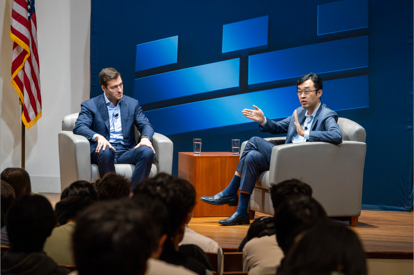 Peng Zhao speaking at a UC Berkeley fireside chat, shot by Nico Hend Photography
