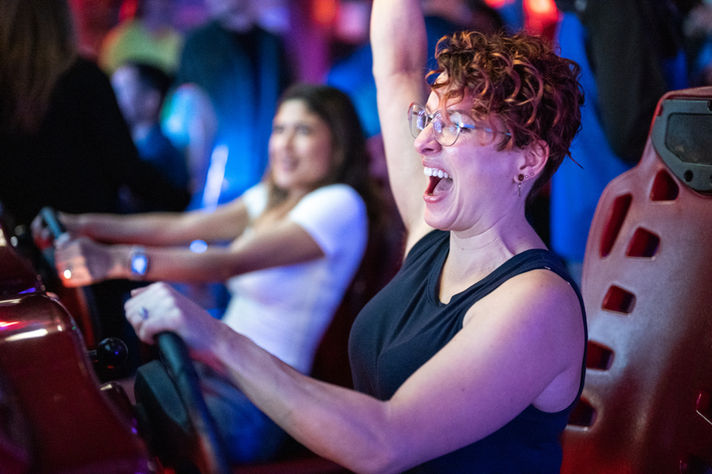 Employee at arcade game corporate offsite celebration San Francisco