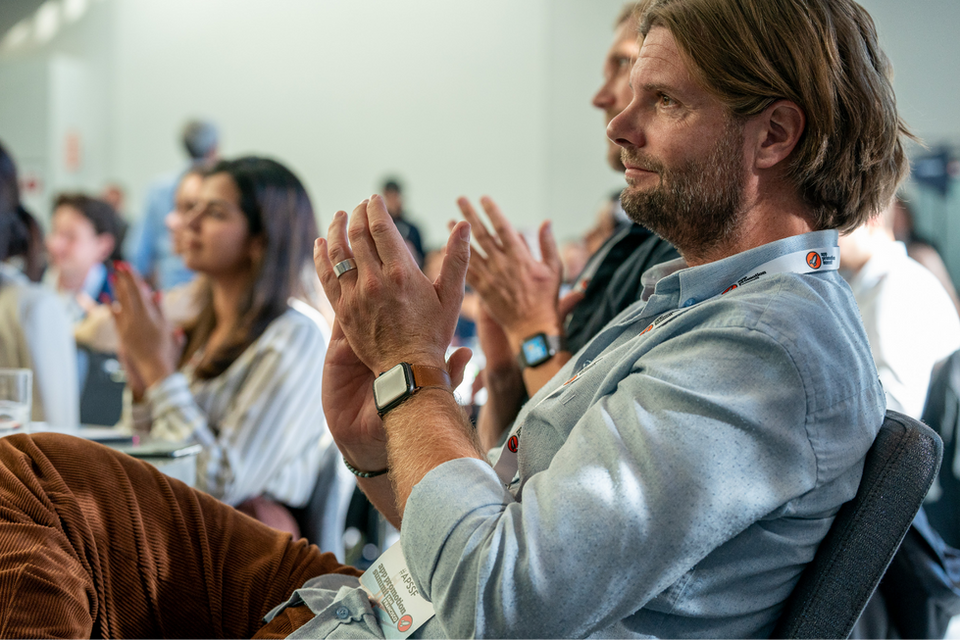 Man clapping in the audience at a W Hotel conference in San Francisco, photographed by Nico Hend Event Photography.
