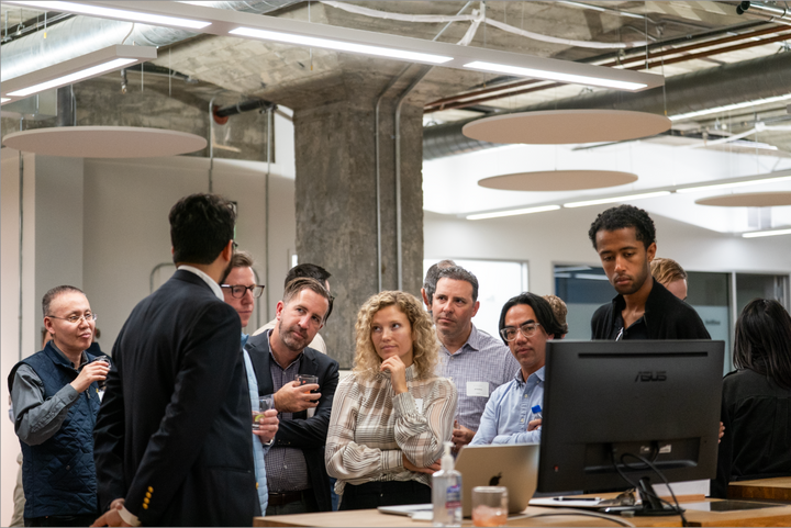 Guests watching a Dealpath product demo during an onsite cocktail party in San Francisco