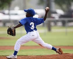 Youth baseball athlete pitching