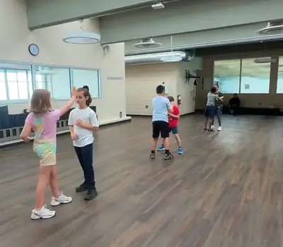 Kids practicing self defense in a private group class with Streetwise Martial Arts.