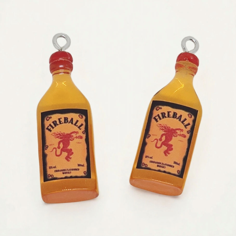 cinnamon whisky bottle charm made of resin on plain background